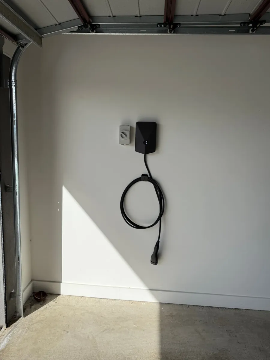 Evnex EV charger installed inside a garage with tidy coiled cable