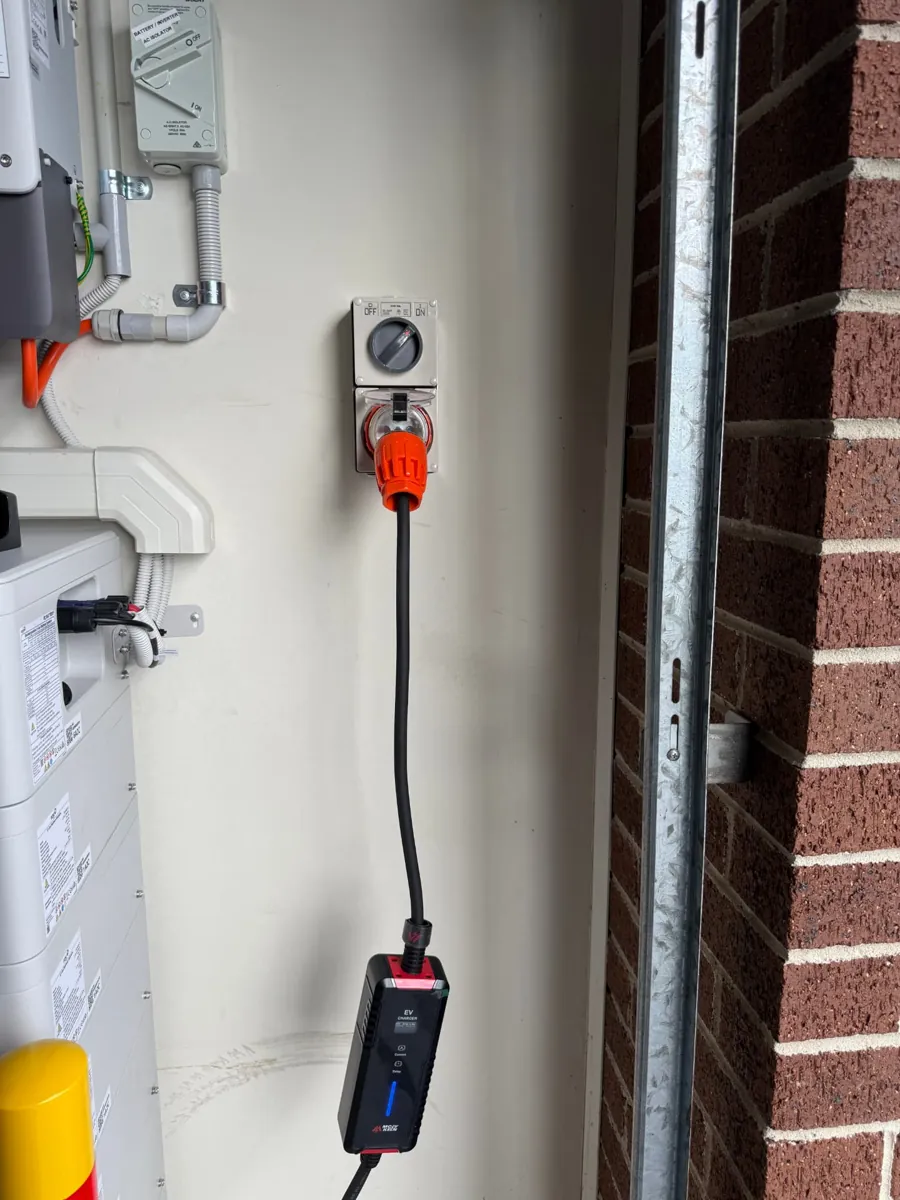 Portable EV charger plugged into a dedicated 32A outlet