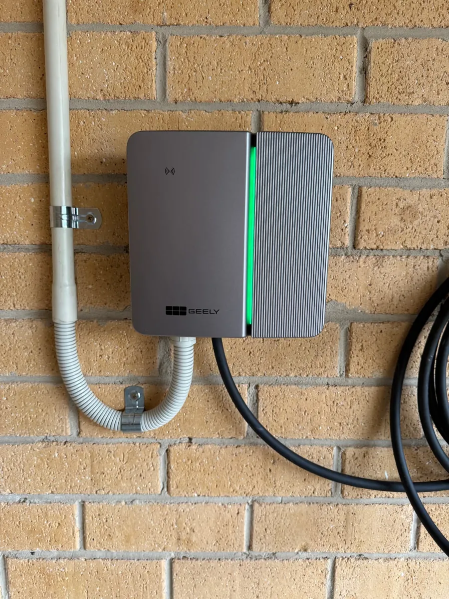Geely EV charger installed on a brick wall with tidy conduit