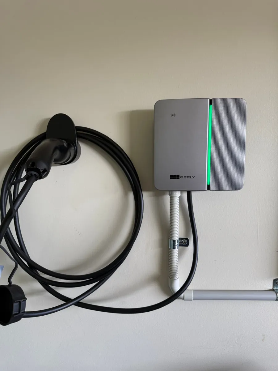 Geely EV charger installed with cable holster in a garage