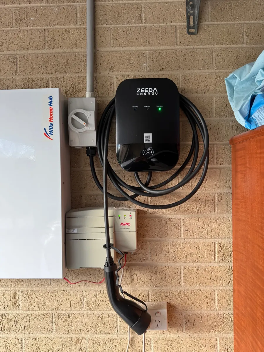 Zeeda Energy EV charger installed next to a home hub on a brick wall
